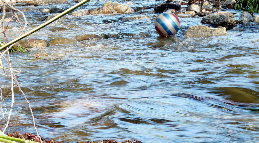 Ball Floating on Stream Photograph by Jeff Lowe