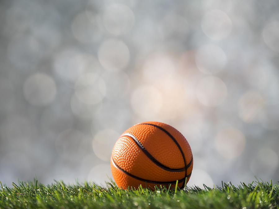 Ball of basketball  ball  on a surface of  grass of a soccer field Photograph by Jose A. Bernat Bacete