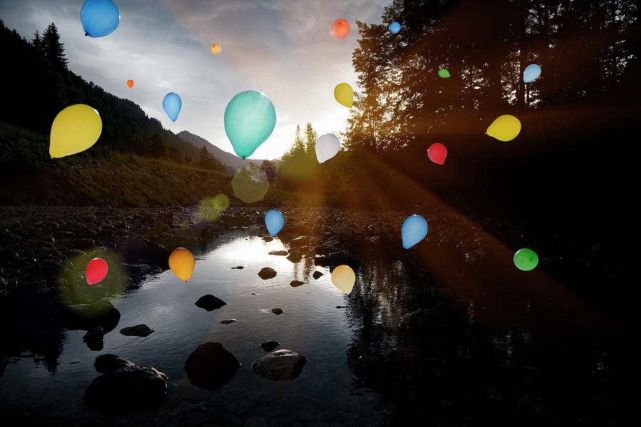 Balloons Floating Over Still Rocky Lake Photograph by Henglein And Steets
