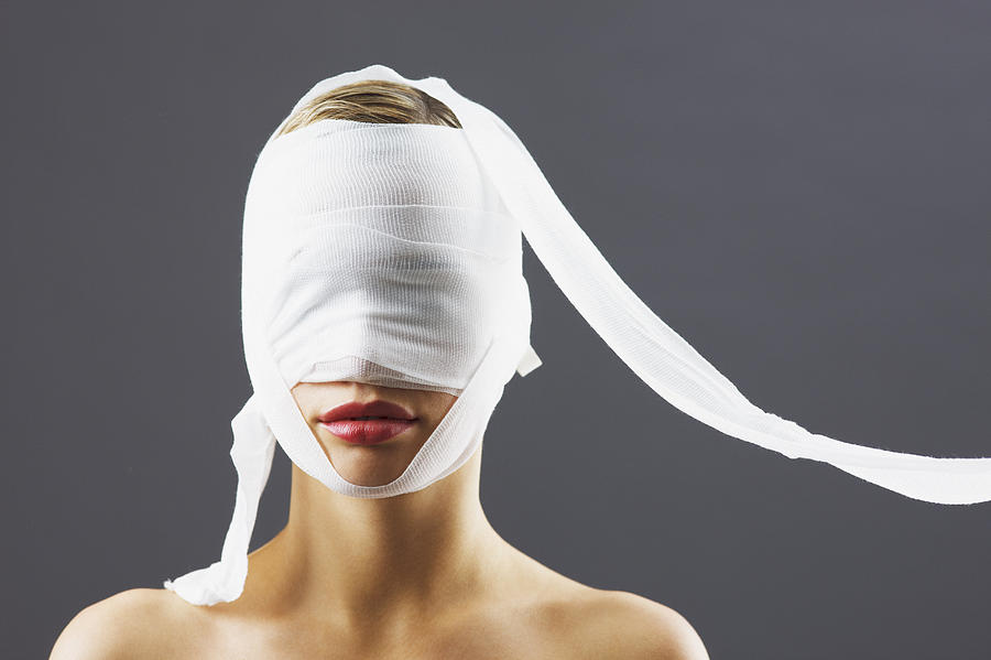 Bandage covering womans face Photograph by Robert Daly
