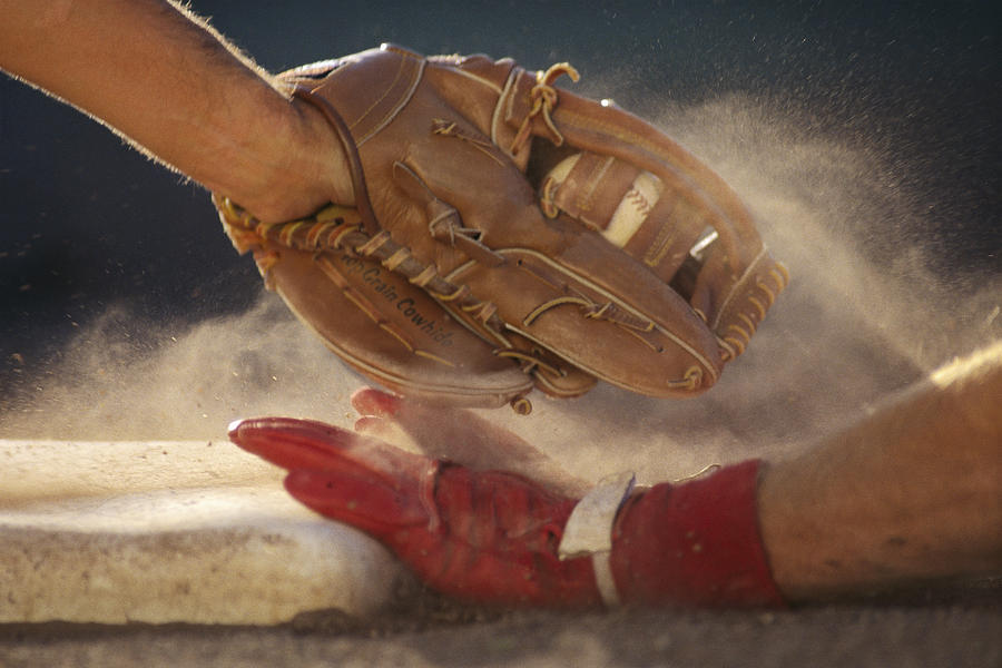 Baseball player sliding into base, baseman tagging player, close-up Photograph by David Madison