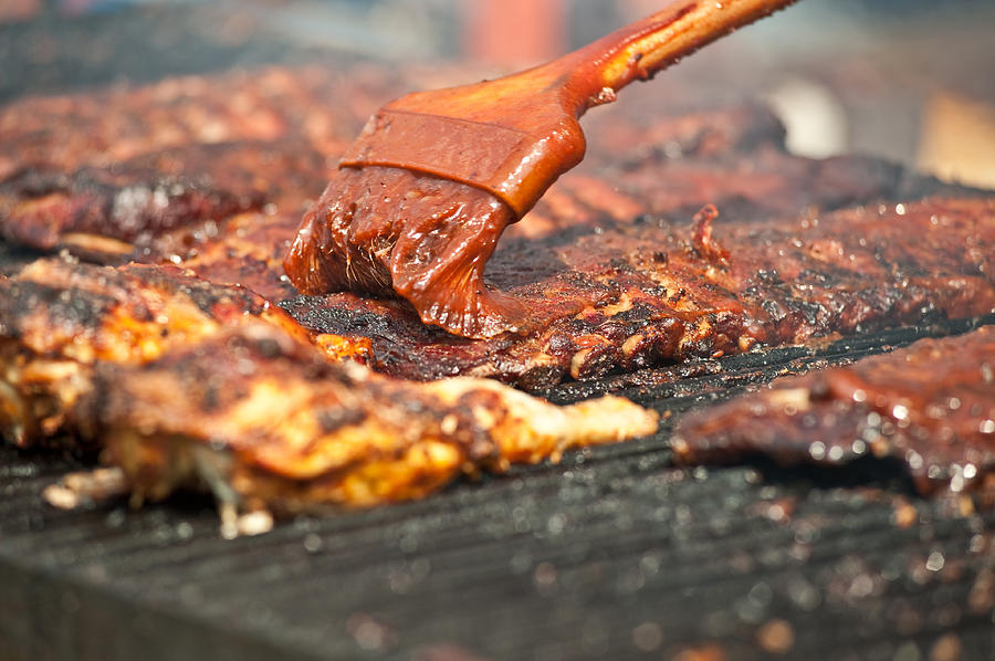 Basting tasty ribs on the barbeque. Photograph by Marek Poplawski