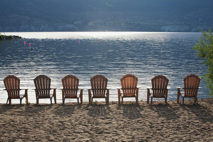 Beach Chairs Lined Up On The Shoreline Photograph by Michael Interisano / Design Pics