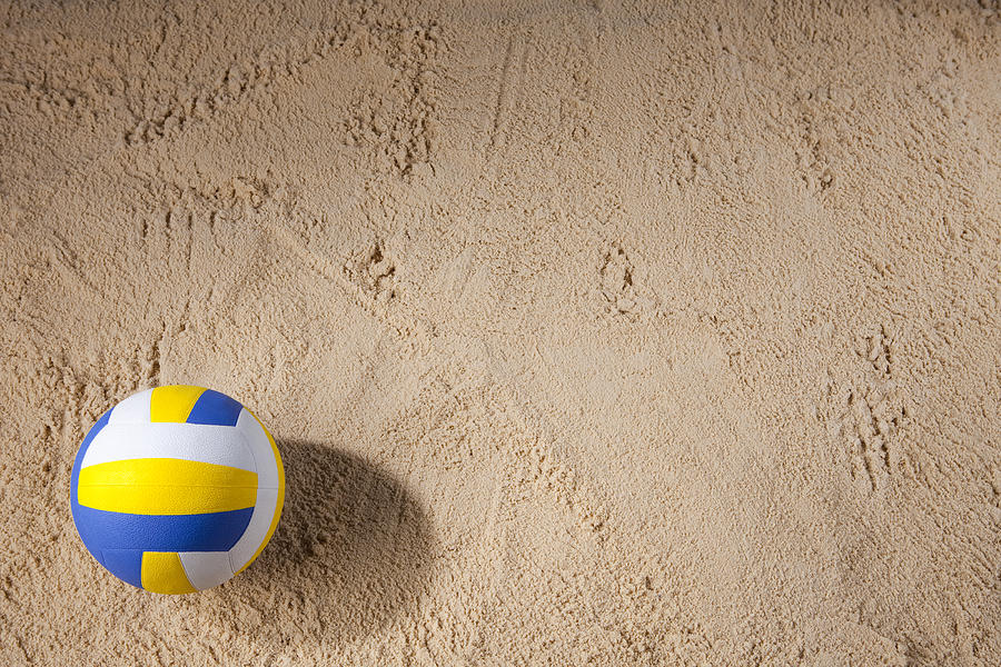 Beach volleyball sitting on the sand Photograph by Vandervelden