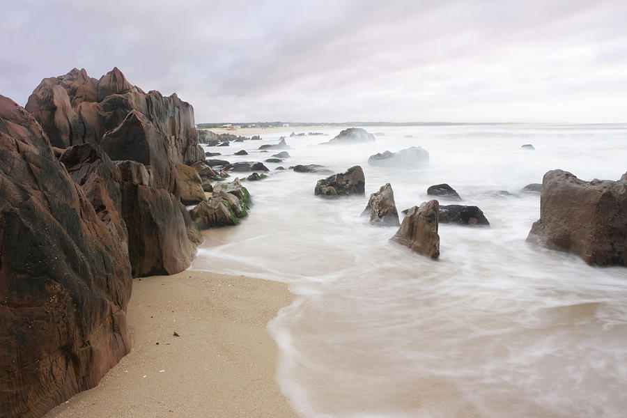 Beach With Rocks And Blurry Waves At Photograph by Lucop