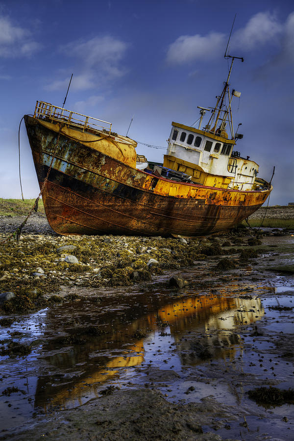 Beached Fishing Trawler Reflecting while waiting for the Tide Photograph by Dennis Dame