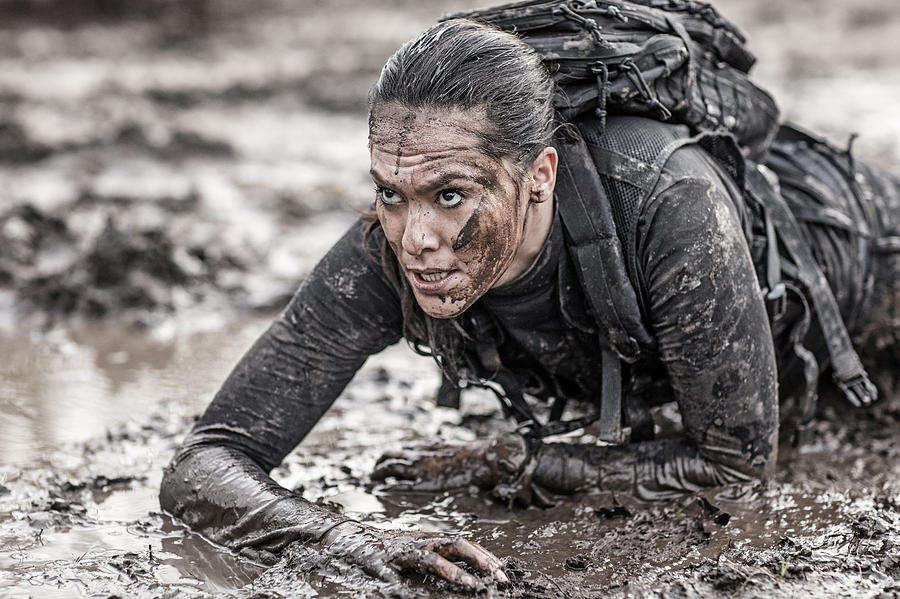 Beautiful brunette female military swat security anti terror agent crawling during operations in muddy sand Photograph by Lorado