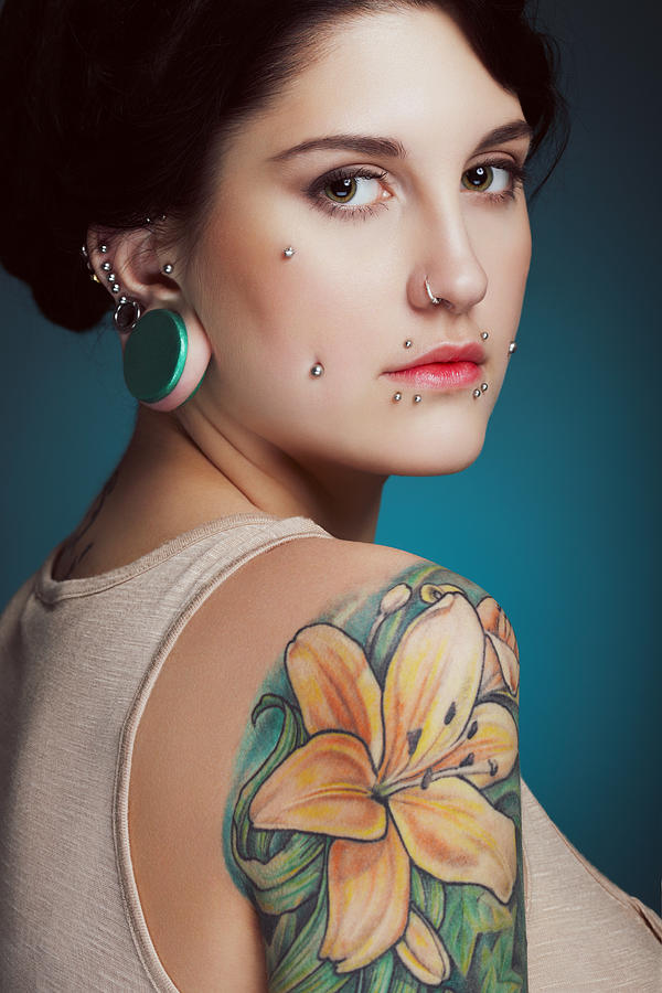 Beautiful girl with face piercing and tattoo Photograph by Lambada