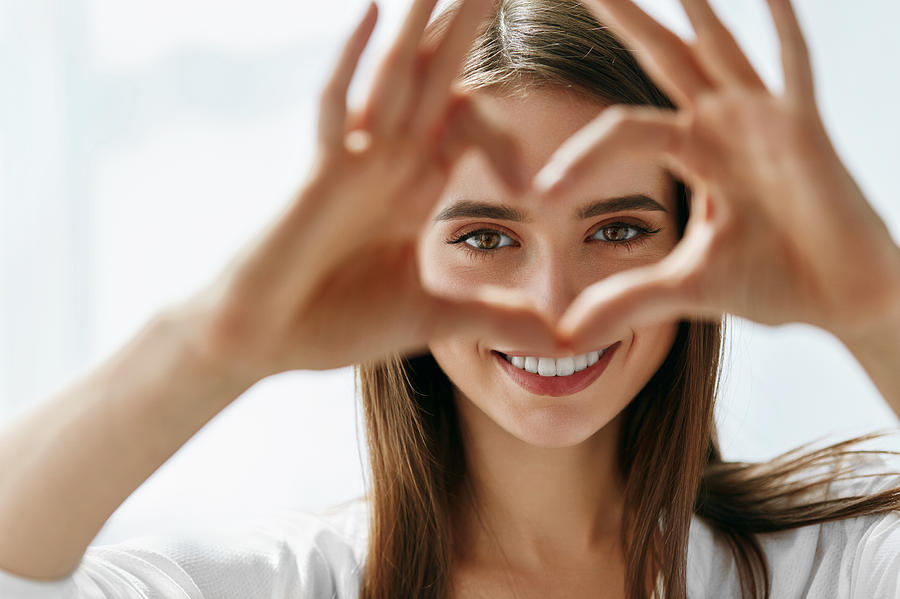 Beautiful Happy Woman Showing Love Sign Near Eyes. Photograph by Puhhha