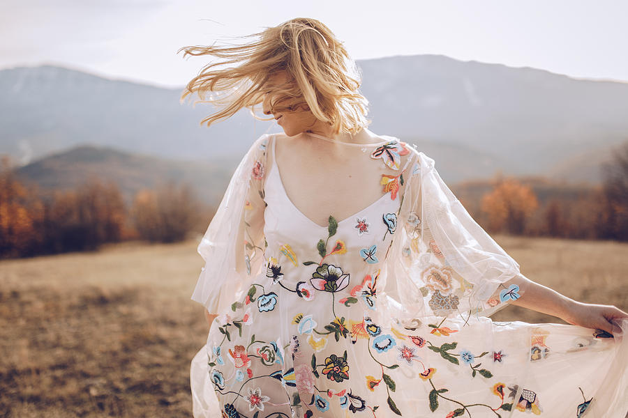 Beautiful hippie woman dancing in a meadow Photograph by South_agency