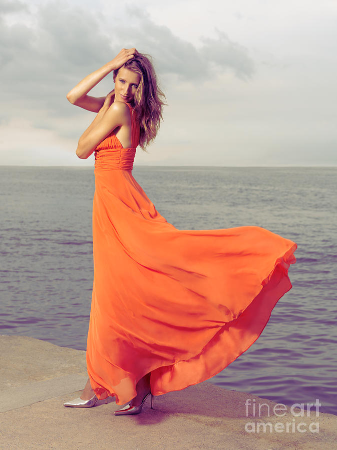 Beautiful Woman In Orange Dress On Sea Shore Photograph By Oleksiy Maksymenko