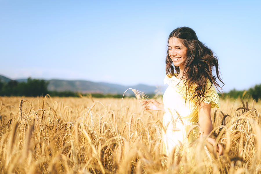 Beautiful Young Woman In A Wheat Golden Field Photograph by Eclipse_images