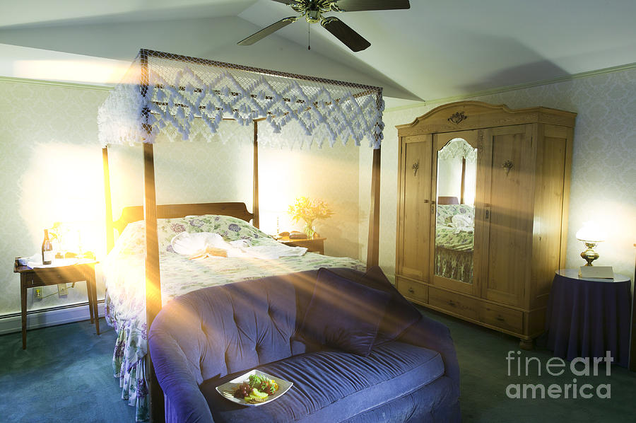 Bedroom with sunlight streaking through a window. Photograph by Don Landwehrle