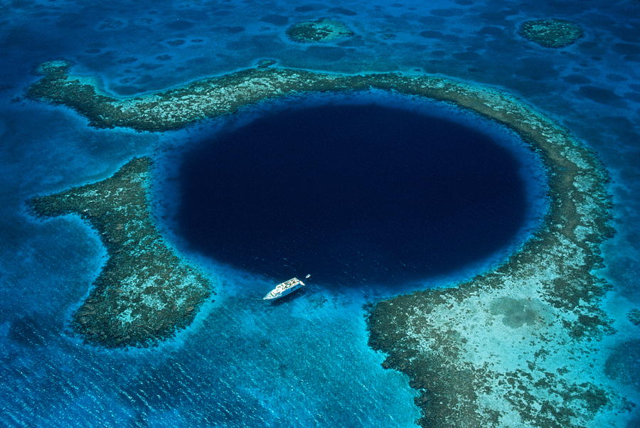 Belize, Lighthouse Reef, boat moored at Blue Hole, aerial view Photograph by Schafer & Hill