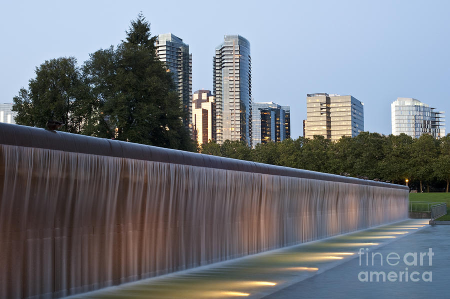 Bellevue skyline from city park with fountain and waterfall at s Photograph by Jim Corwin