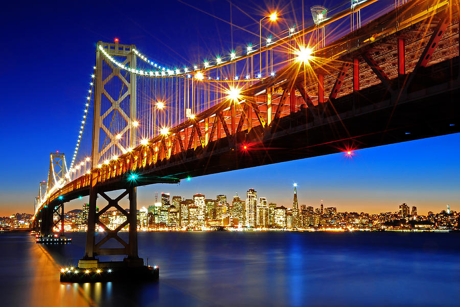 Below the Bay Bridge and San Francisco Skyline Photograph by Joel Thai