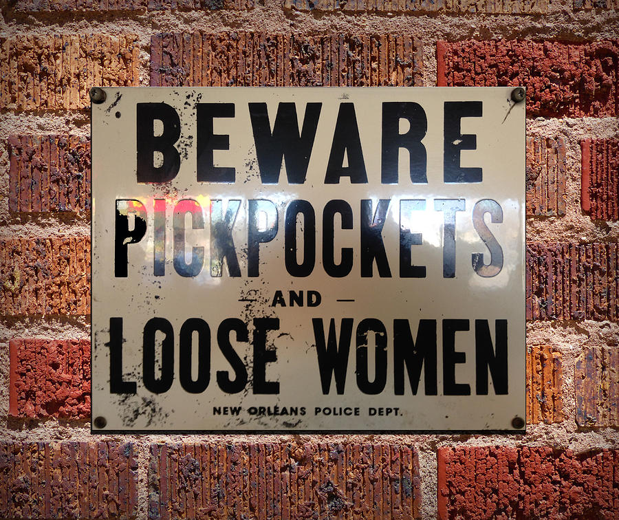 Beware Pickpockets and Loose Women Sign on Brick Wall Photograph by Robert J Sadler