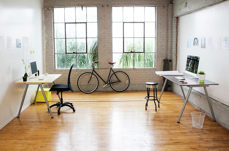 Bicycle And Desks In Modern Office Photograph by Sam Diephuis