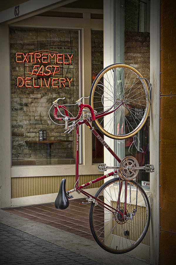 Bicycle attached to wall outside of fast food restaurant Photograph by Randall Nyhof
