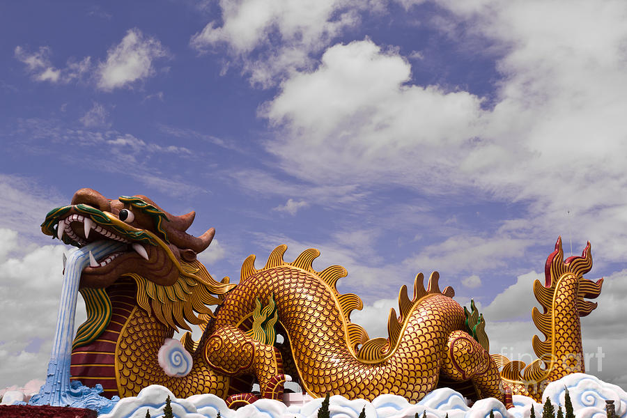 Big dragon statue and blue sky with cloud in Thailand Photograph by Tosporn Preede