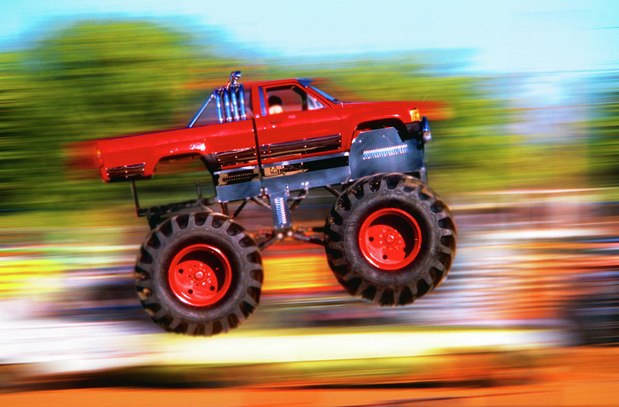 Sports Photograph - Big Wheeled Red Truck Jumping Blurred by Vintage Images