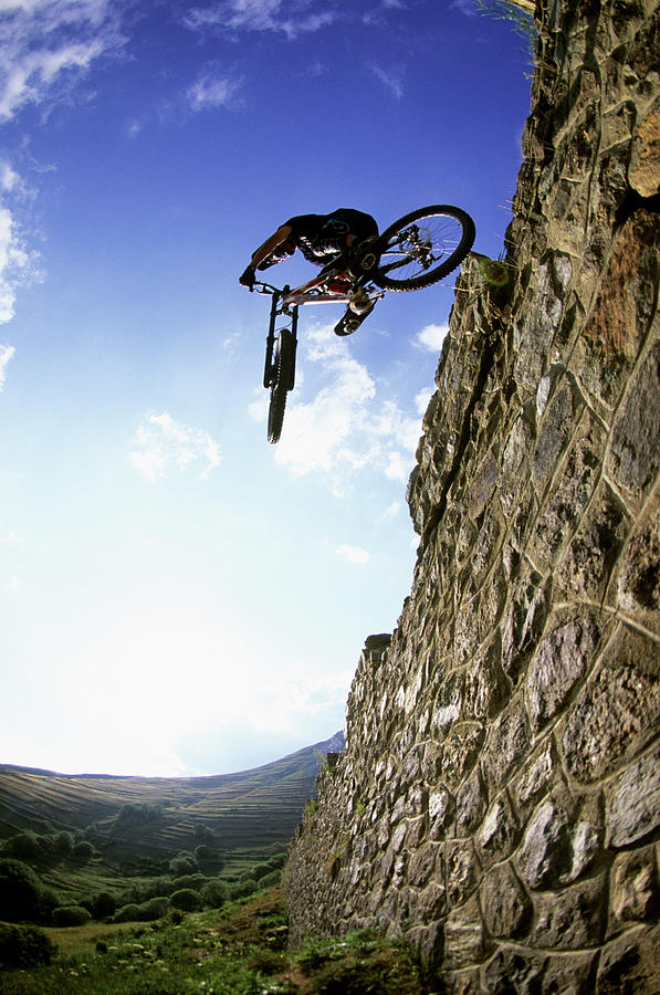 Action Photograph - Biker Making Wall Jump In France by Scott Markewitz