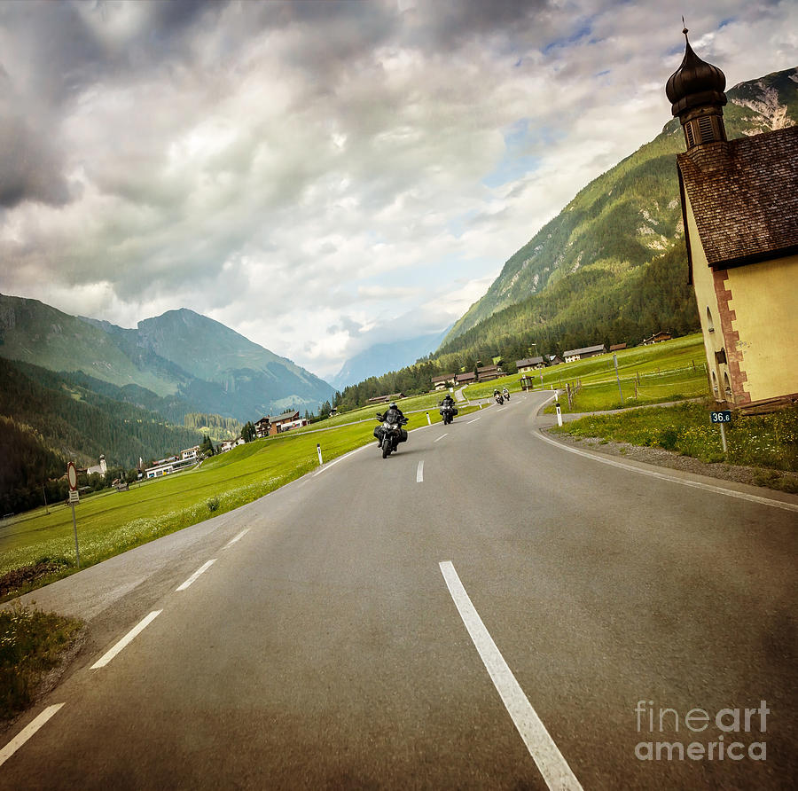 Biker race across mountainous village Photograph by Anna Om