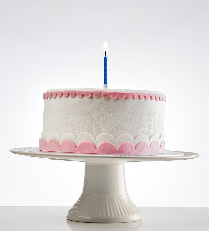 Birthday Cake On Cakestand With One Burning Candle Photograph by Pidjoe