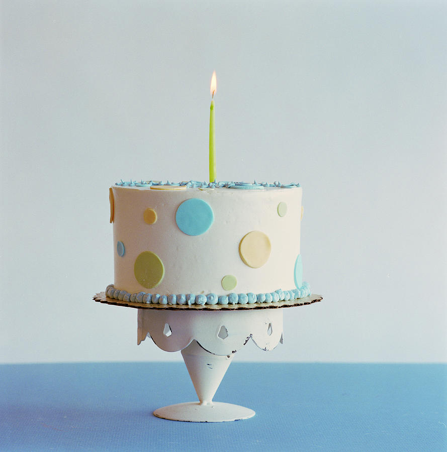 Birthday cake with one candle Photograph by Rebecca Emery