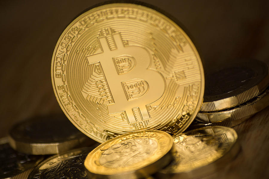 Bitcoin and one pound coins Photograph by Alphotographic