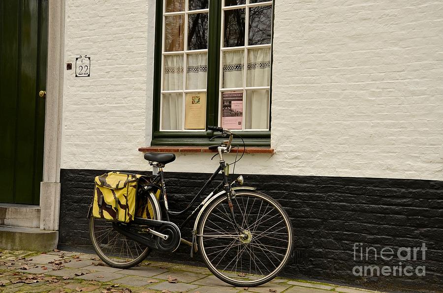 Black cycle rests on window sill Bruges Belgium Photograph by Imran Ahmed