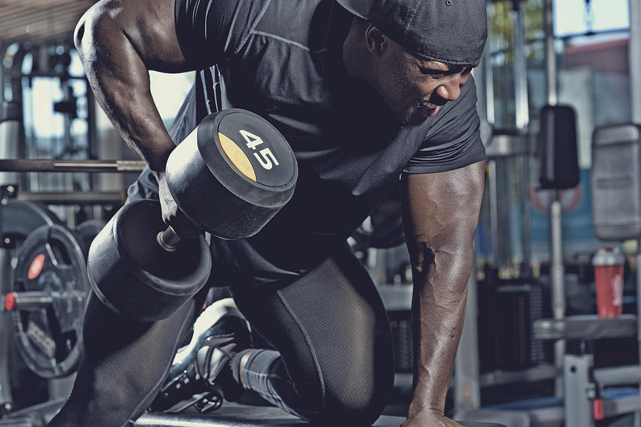 Black Male Lifting Dumbbells At A Gym Photograph by Lorado