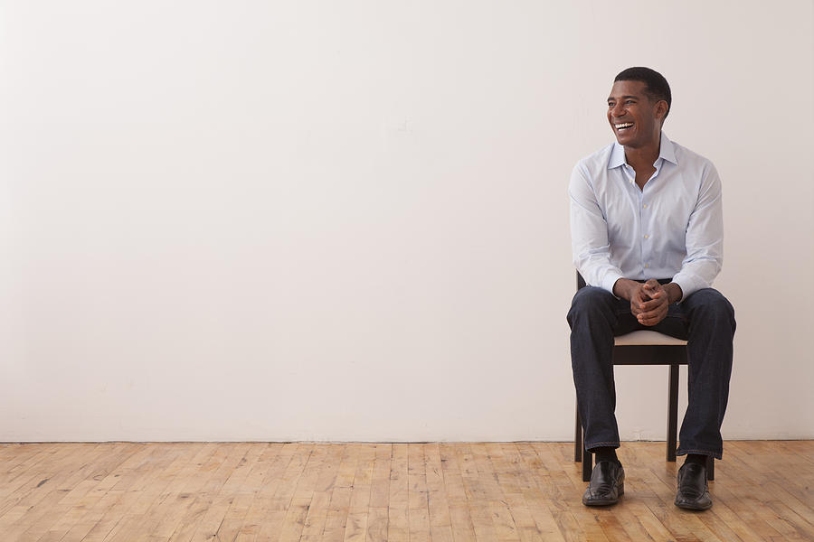 Black man sitting in chair Photograph by Peter Dressel
