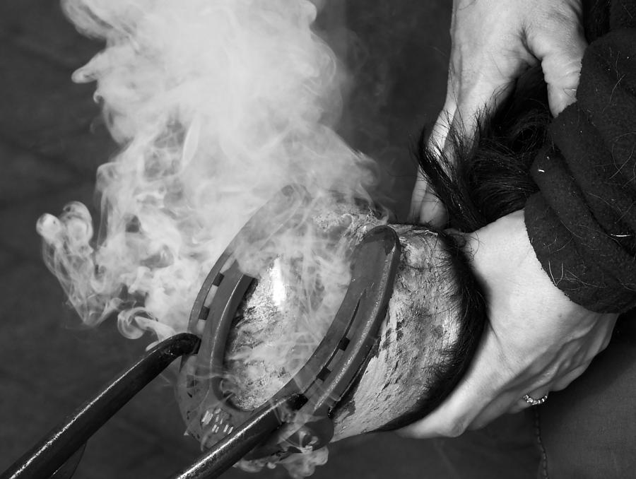 Black And White Photograph - Blacksmith with horseshoe - traditional craft by Matthias Hauser