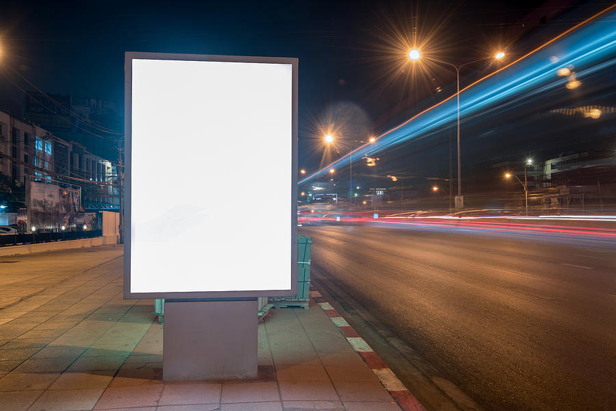 Blank Billboard on City Street at Night. Outdoor advertising Photograph by Boonchai Wedmakawand