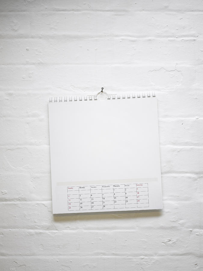 Blank calendar hanging on white brick wall Photograph by Jw Ltd
