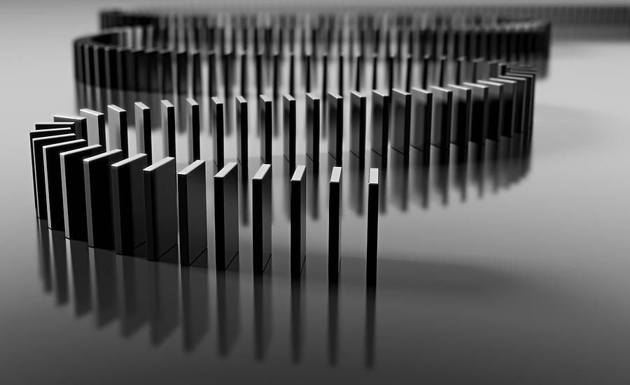 Blank domino pieces set up to fall over in a chain reaction Photograph by Fpm