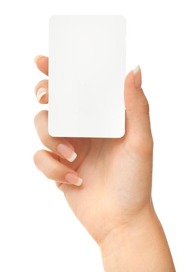 Blank play card in woman hand on white Photograph by Deepblue4you