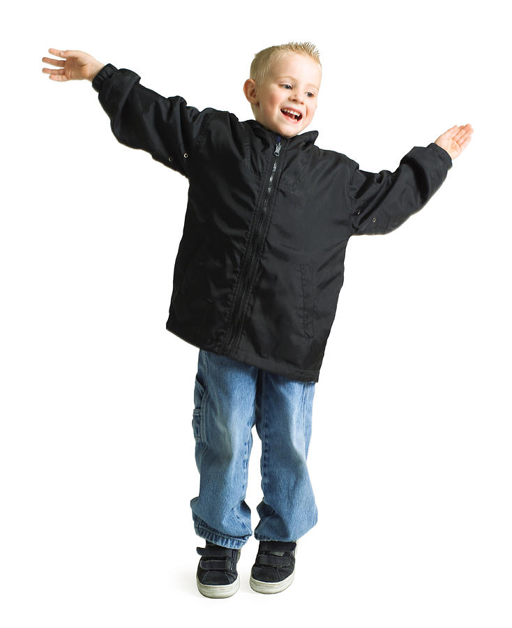 Blond Caucasian Boy Jumping And Similing With Arms Outstreached Photograph by Photodisc