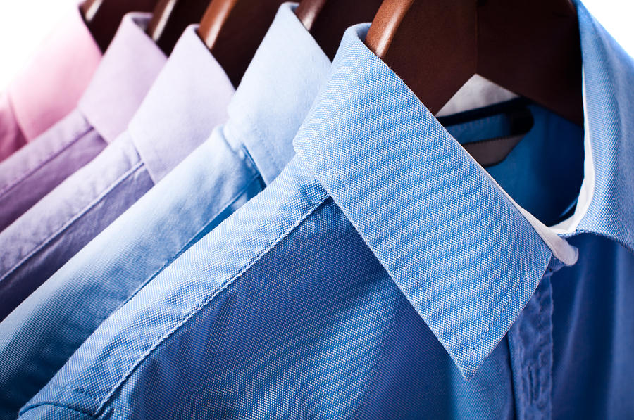 Blue and pink elegant button down shirts hanging on hangers Photograph by Domin_domin