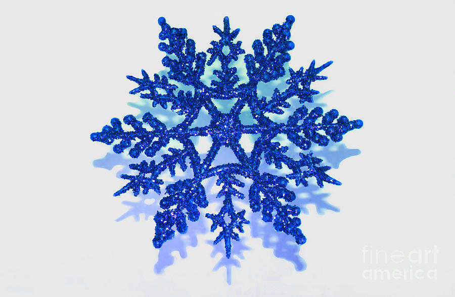 Glitter covered blue snowflake with on transparent
