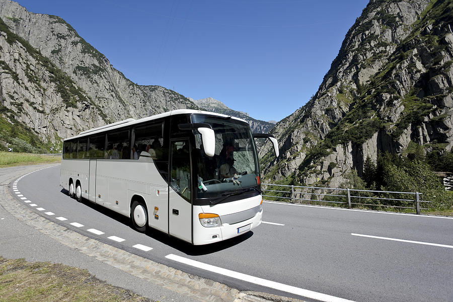 Blue sky over white bus crossing the alpes Photograph by Grafissimo