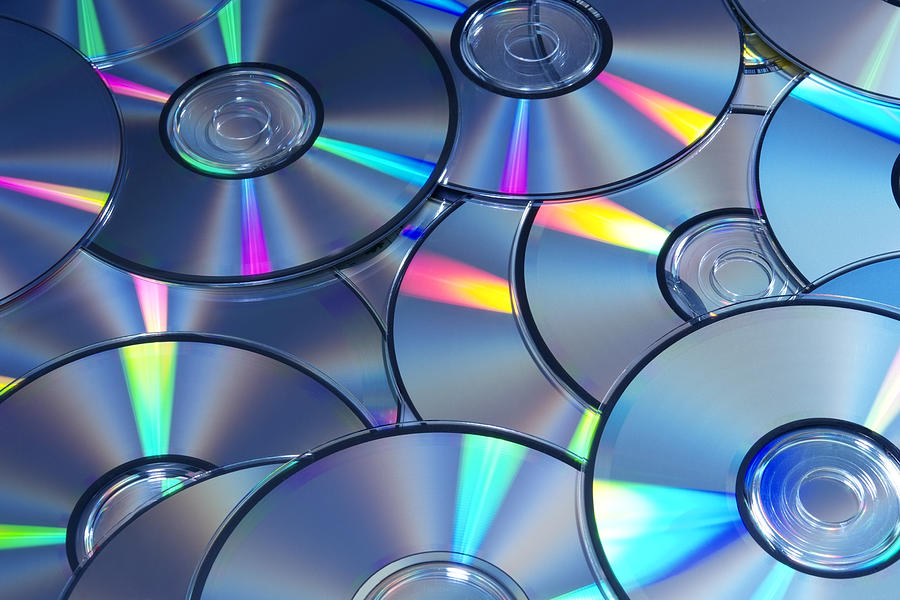 Blue tinted image of stacked CD/DVD texture background Photograph by Kyoshino