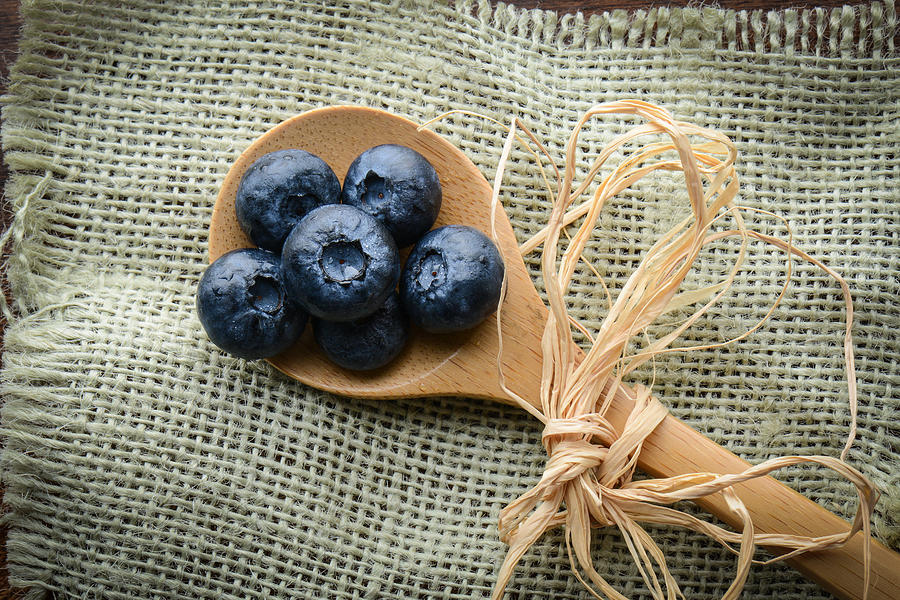 Blueberries on a Spoon with Burlap Woven Background Photograph by Brandon Bourdages