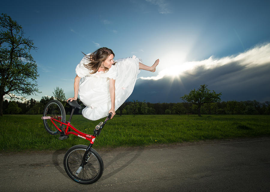 Sports Photograph - BMX Flatland rider Monika Hinz jumps in Wedding Dress by Matthias Hauser