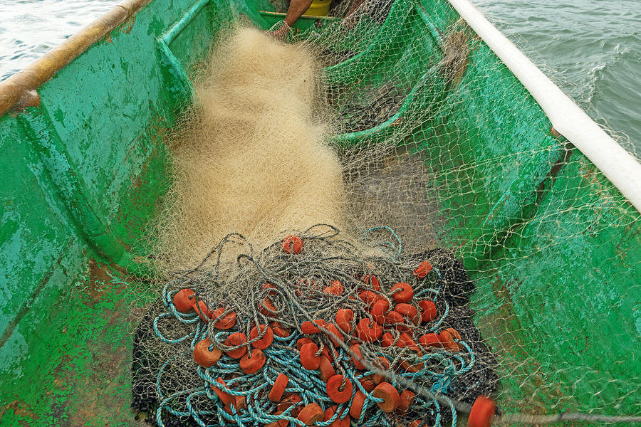 Boat and fishing net Photograph by Marek Poplawski
