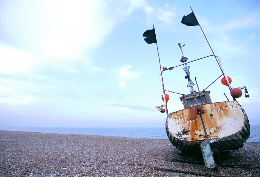 Pebbles Photograph - Boat On A Beach by Paul Avis/science Photo Library