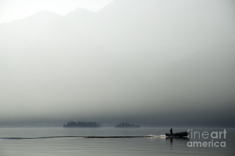 Boat on a foggy lake Photograph by Mats Silvan