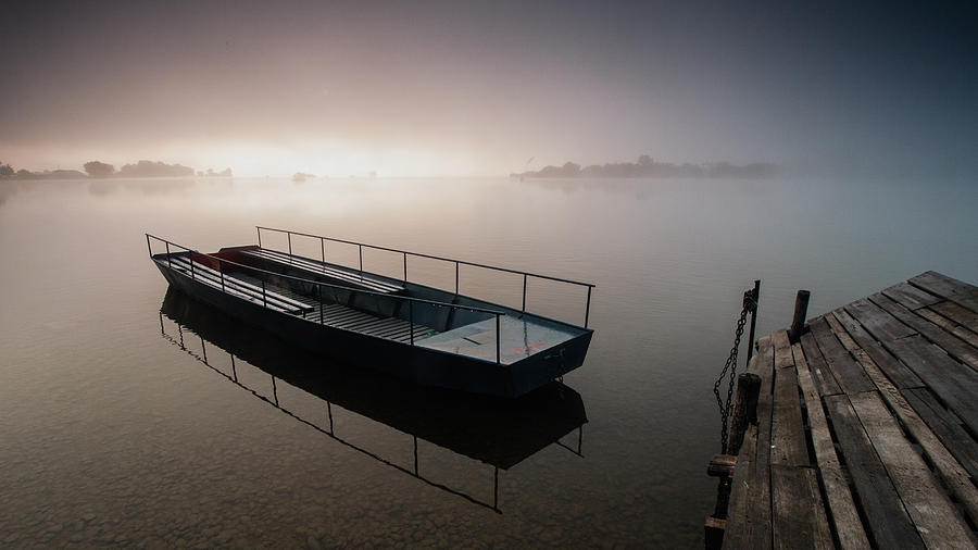 Boat on foggy lake II Photograph by Davorin Mance