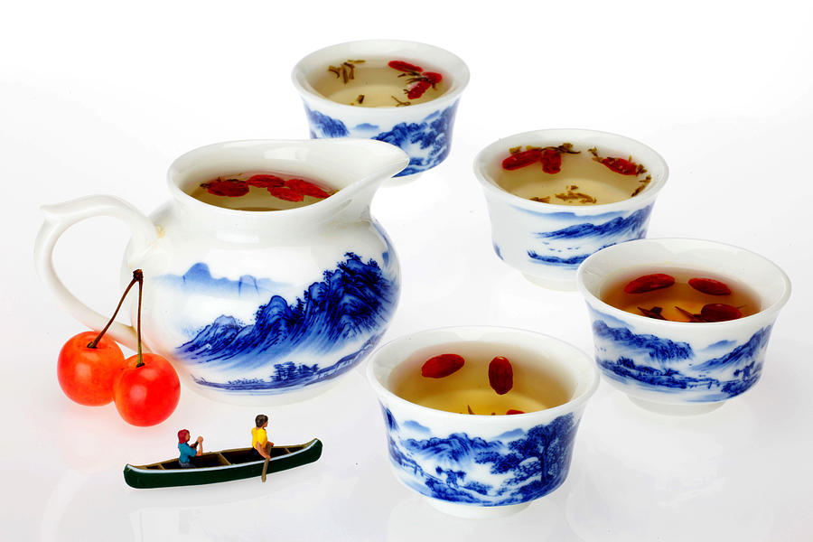 Boating among china tea cups little people on food Photograph by Paul Ge